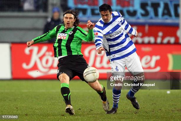 Tiago of Duisburg tackles Djordje Rakic of Muenchen during the second Bundesliga match between MSV Duisburg and 1860 Muenchen at the MSV Arena on...