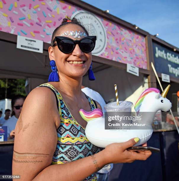 Festivalgoer enjoys a Unicorn Float from Taiyaki NYC during the 2018 Firefly Music Festival on June 17, 2018 in Dover, Delaware.