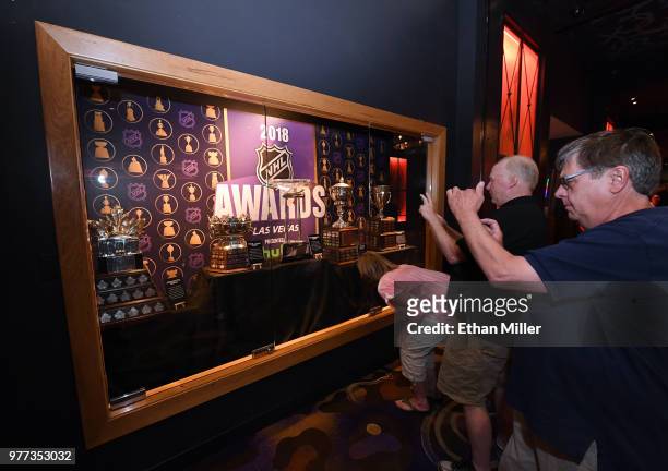 Guests take photos of the Conn Smythe Trophy, the Frank J. Selke Trophy, the Presidents' Trophy, the Lady Byng Memorial Trophy and the Calder...