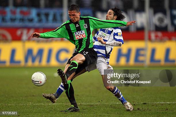 Olcay Sahan of Duisburg tackles Jose Holebas of Muenchen during the second Bundesliga match between MSV Duisburg and 1860 Muenchen at the MSV Arena...