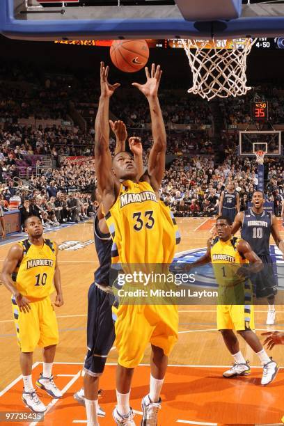 Jimmy Butler of the Marquette Golden Eagles pulls down a rebound during the Big East Semi-Final College Basketball Tounament game against the...