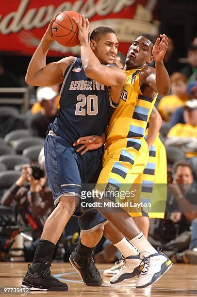 Jerrelle Benimon of the Georgetown Hoyas tries to get by Jimmy Butler of the Marquette Golden Eagles during the Big East Semi-Final College...