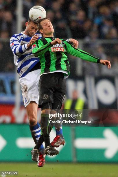 Bjoern Schlicke of Duisburg and Stefan Aigner of Muenchen head the ball during the second Bundesliga match between MSV Duisburg and 1860 Muenchen at...