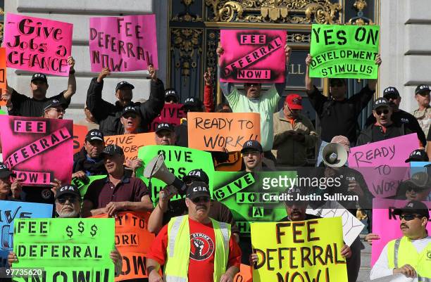 Union workers hold signs during a rally in support of a proposed stimulus reform package for the City of San Francisco March 15, 2010 in San...