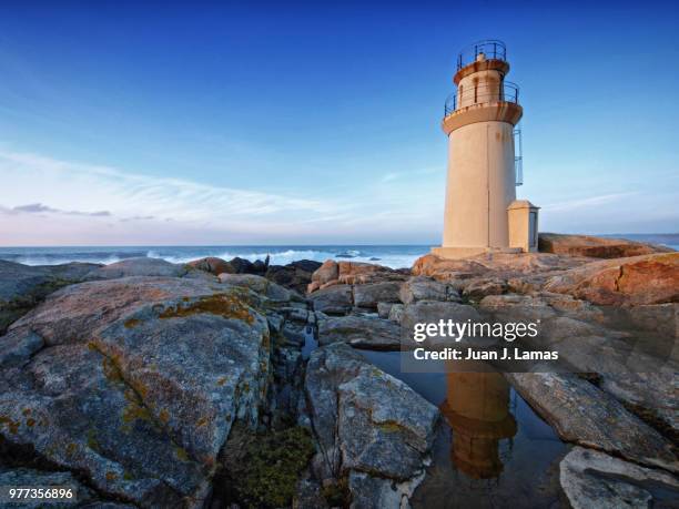 rocks, water and lighthouse, costa de la muerte, galicia, spain - muerte stock pictures, royalty-free photos & images