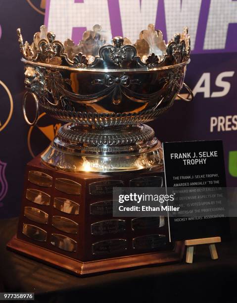 The Frank J. Selke Trophy is displayed in a glass case at the Hard Rock Hotel & Casino in advance of the 2018 NHL Awards on June 17, 2018 in Las...