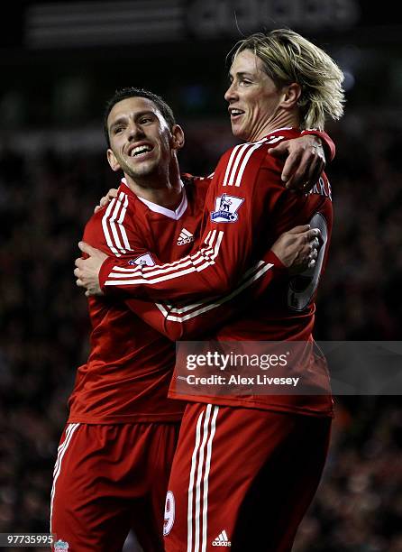 Fernando Torres of Liverpool celebrates scoring the opening goal with team mate Maxi Rodriguez during the Barclays Premier League match between...