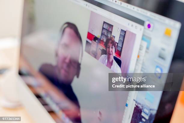 May 2018, Germany, Jena: The computer screen shows Christine Zollman, dermatology and venereology specialist, and Max Schulz, software developer at...