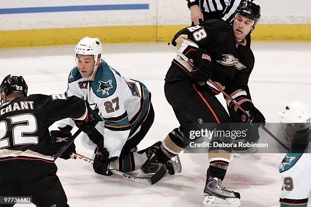 Manny Malhotra of the San Jose Sharks falls to the ice battling for the puck against Kyle Chipchura of the Anaheim Ducks during the game on March 14,...
