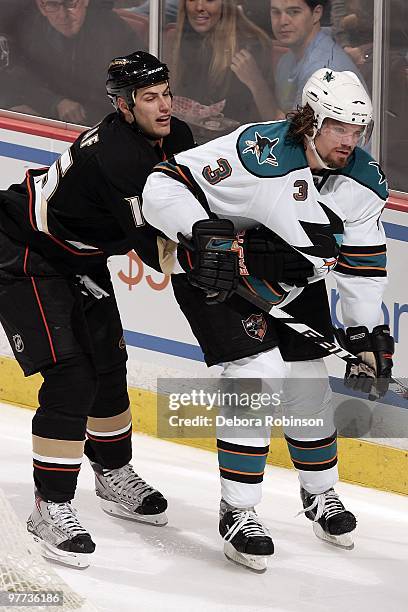 Ryan Getzlaf of the Anaheim Ducks reaches for the puck against Douglas Murray of the San Jose Sharks during the game on March 14, 2010 at Honda...