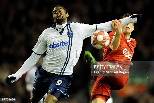 Frederic Piquionne of Portsmouth battles for the ball with Daniel Agger of Liverpool during the Barclays Premier League match between Liverpool and...