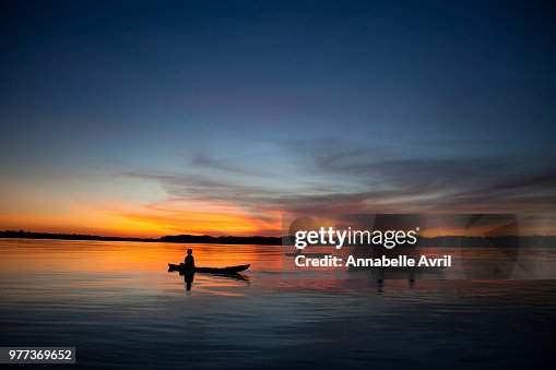 Silhouette of fishermen at sunset on Amazon River, Iquitos, Peru Silhouette of fishermen at sunset on Amazon River, Iquitos, Peru