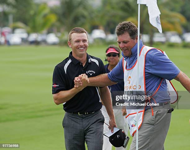 Derek Lamely celebrates with his caddie Greg Hickman after finishing his round on the ninth green during the final round of the Puerto Rico Open...