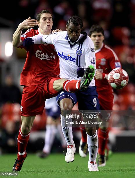 Frederic Piquionne of Portsmouth battles for the ball with Daniel Agger of Liverpool during the Barclays Premier League match between Liverpool and...