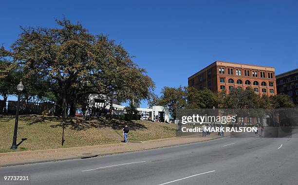 This photo taken on March 13 shows the Grassy Knoll and the former Texas School Book Depository Building in Dealey Plaza, where the 1963 assasination...