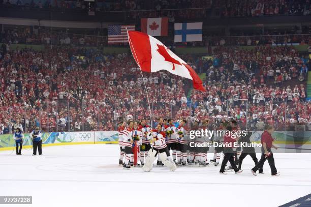 Winter Olympics: Canada goalie Roberto Luongo victorious with flag after Sidney Crosby won game by scoring overtime goal vs USA during Men's Gold...