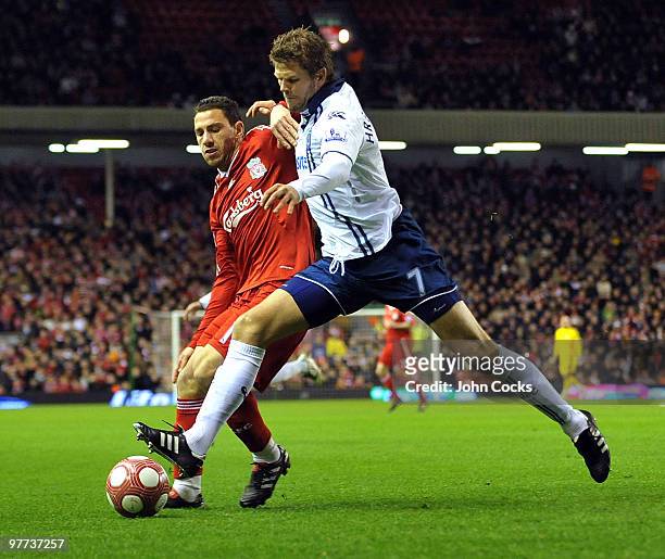 Maxi Rodriguez of Liverpool competes with Hermann Hreidarsson of Portsmouth during the Barclays Premier League match between Liverpool and Portsmouth...