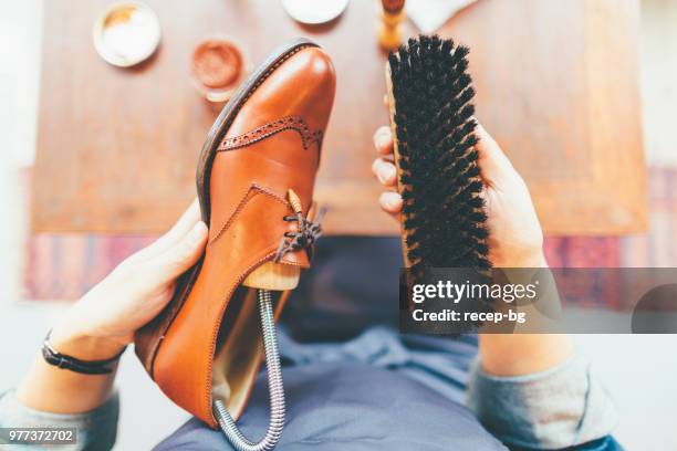 woman brushing shoe - polishing shoes stock pictures, royalty-free photos & images