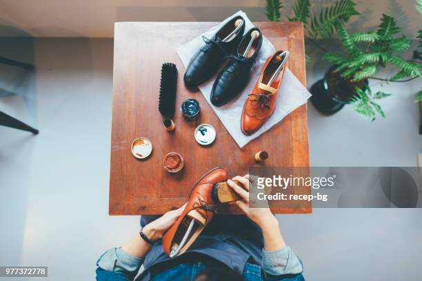 woman brushing shoe - polishing shoes stock pictures, royalty-free photos & images