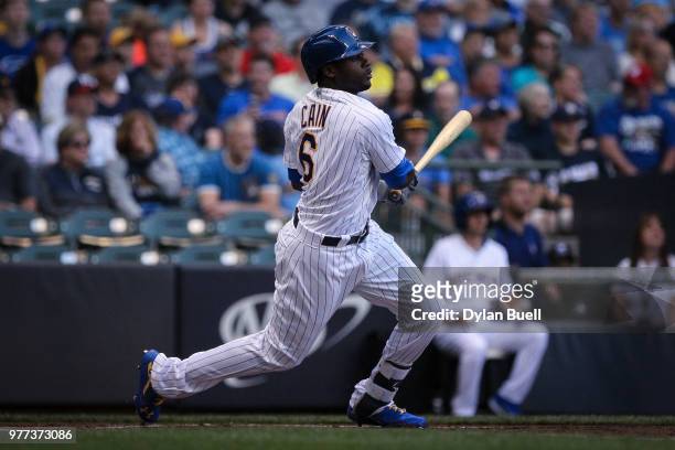 Lorenzo Cain of the Milwaukee Brewers hits a single in the first inning against the Philadelphia Phillies at Miller Park on June 15, 2018 in...