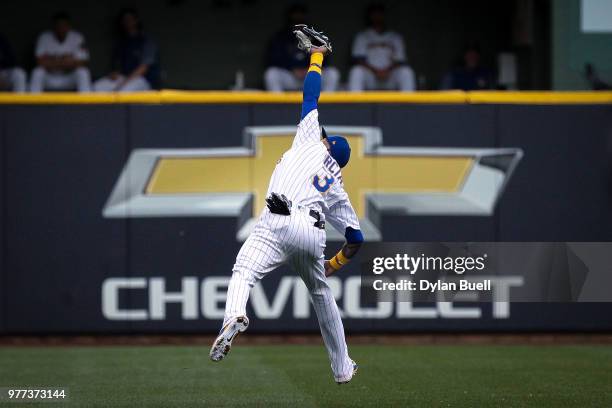 Orlando Arcia of the Milwaukee Brewers leaps to catch a fly ball in the second inning against the Philadelphia Phillies at Miller Park on June 15,...