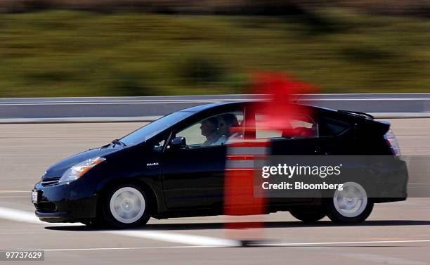 Members of the media test the brakes on a Toyota Prius after a news conference in San Diego, California, U.S., on Monday, March 15, 2010. Toyota...