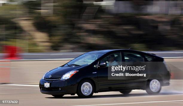 Members of the media test the brakes on a Toyota Prius after a news conference in San Diego, California, U.S., on Monday, March 15, 2010. Toyota...