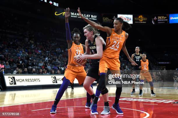 Carolyn Swords of the Las Vegas Aces goes to the basket between Sancho Lyttle and DeWanna Bonner of the Phoenix Mercury on June 17, 2018 at the...
