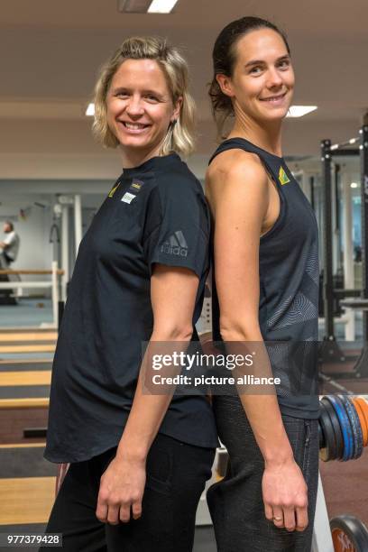 April 2018, Germany, Hamburg: Laura Ludwig and Kira Walkenhorst, German beach volleyball Olympic winners and world champions, stand next to each...