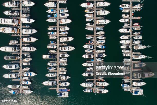 Yachts and boats sit moored at the marina in this aerial photograph taken above the Haeundae district in Busan, South Korea, on Wednesday, June 6,...