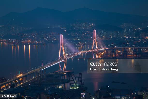 The Busan Harbor Bridge stands illuminated at dusk in Busan, South Korea, on Wednesday, June 6, 2018. South Korea will release its May import and...