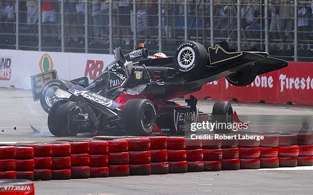 The KV Racing Technology Dallara Honda of Mario Moraes crashes on top of the Andretti Autosport Dallara Honda of Marco Adretti after the two cars...