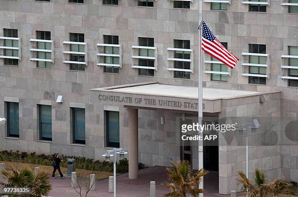 The US national flag flutters at half-mast at the entrance of the consulate of the United States in Ciudad Juarez, Chihuahua state, Mexico on March...