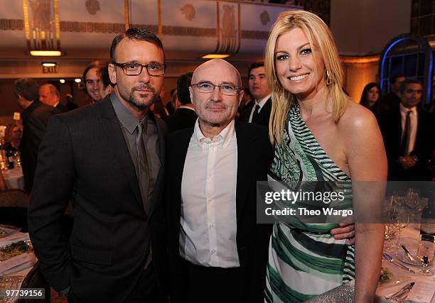 *Exclusive* Tim McGraw and Faith Hill pose with inductee Phill Collins at the 25th Annual Rock and Roll Hall of Fame Induction Ceremony dinner at The...