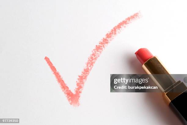 check mark written with red lipstick - fresh deals stockfoto's en -beelden