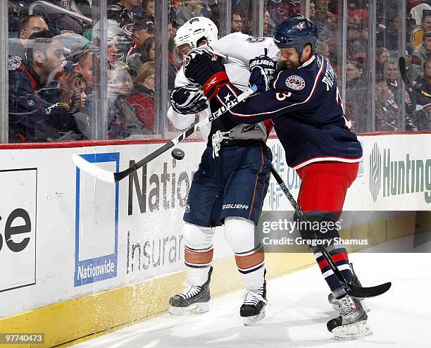 Sam Gagner of the Edmonton Oilers takes a hit from Marc Methot of the Columbus Blue Jackets on March 15, 2010 at Nationwide Arena in Columbus, Ohio.