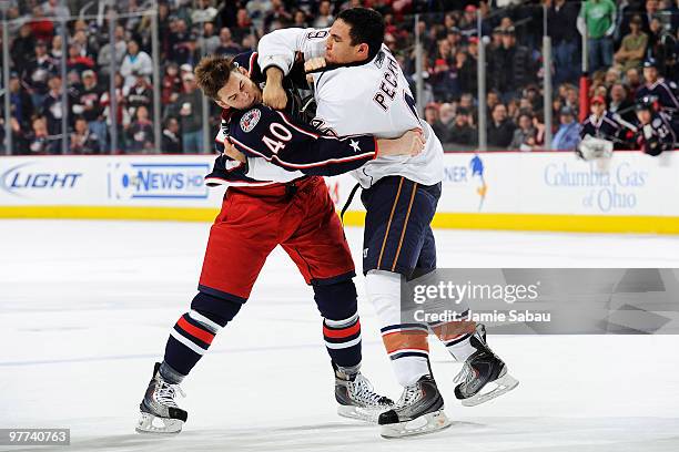 Jared Boll of the Columbus Blue Jackets is punched by Theo Peckham of the Edmonton Oilers during a fight in the first period on March 15, 2010 at...