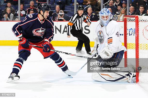 Fedor Tyutin of the Columbus Blue Jackets has his shot go just past goaltender Devan Dubnyk of the Edmonton Oilers during the first period on March...