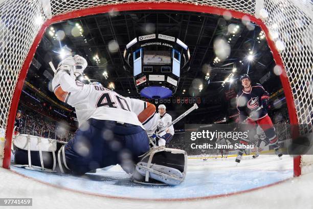 Goaltender Devan Dubnyk of the Edmonton Oilers is unable to stop a shot from Marc Methot of the Columbus Blue Jackets during the third period on...