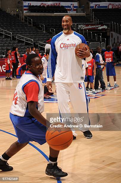 Brian Skinner of the Los Angeles Clippers directs a participant during a pregame clinic for 100 winners of the Jr. Clippers Essay and Sportsmanship...