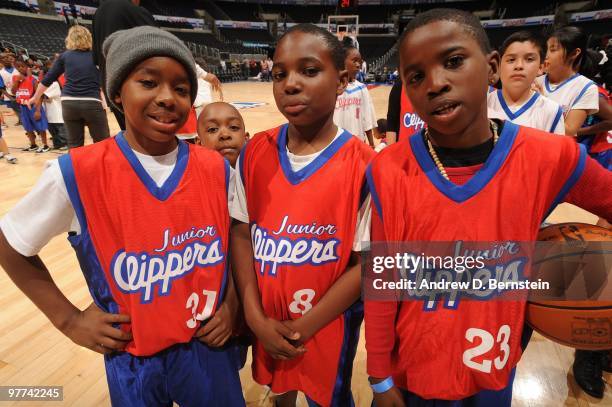 Children pose for a photograph during the Los Angeles Clippers pregame clinic for 100 winners of the Jr. Clippers Essay and Sportsmanship Contest at...