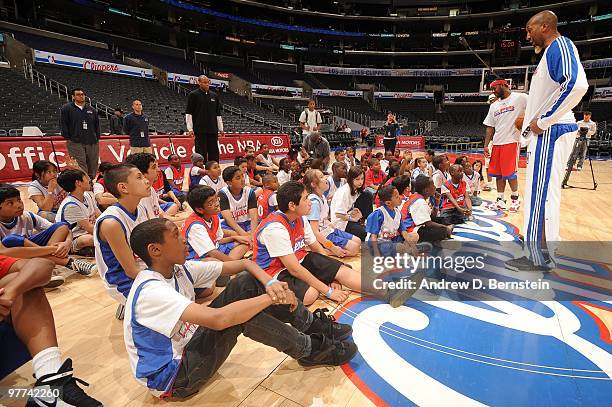 Los Angeles Clipper players Bobby Brown and Brian Skinner speak to participants during a pregame clinic with 100 winners of the Jr. Clippers Essay...