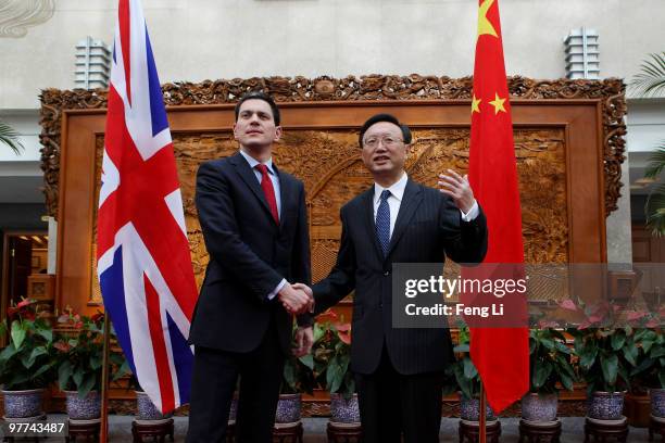Chinese Foreign Minister Yang Jiechi shakes hand with UK Foreign Secretary David Miliband before a meeting at Chinese Foreign Ministry on March 16,...