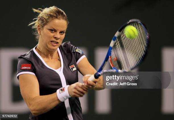 Kim Clijsters of Belgium returns a backhand to Alisa Kleybanova of Russia during the BNP Paribas Open at the Indian Wells Tennis Garden on March 15,...