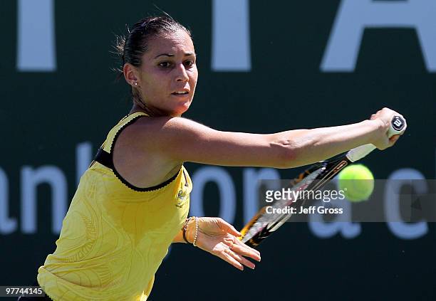 Flavia Pennetta of Italy lunges to return a backhand to Shahar Peer of Israel during the BNP Paribas Open at the Indian Wells Tennis Garden on March...