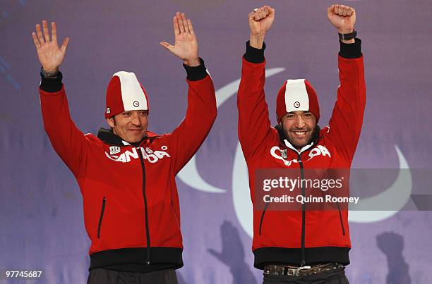 Gold medalist Brian McKeever of Canada and guide Robin Mckeever celebrate during the medal ceremony for the Men's 20km Free Visually Impaired on Day...