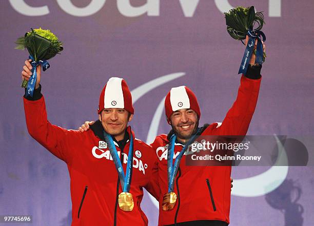 Gold medalist Brian McKeever of Canada and guide Robin Mckeever celebrate during the medal ceremony for the Men's 20km Free Visually Impaired on Day...