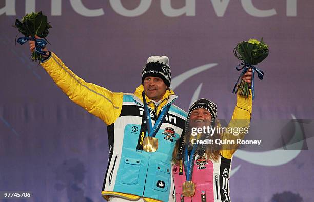 Gold medalist Verena Bentele of Germany and guide Thomas Friedrich celebrate during the medal ceremony for the Women's 15km Free Visually Impaired...