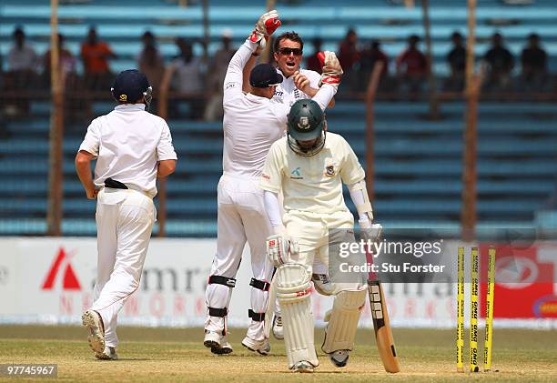 England bowler Graeme Swann celebrates with team mates after taking the wicket of Bangladesh batsman Mushfiqur Rahim for 95 runs during day five of...