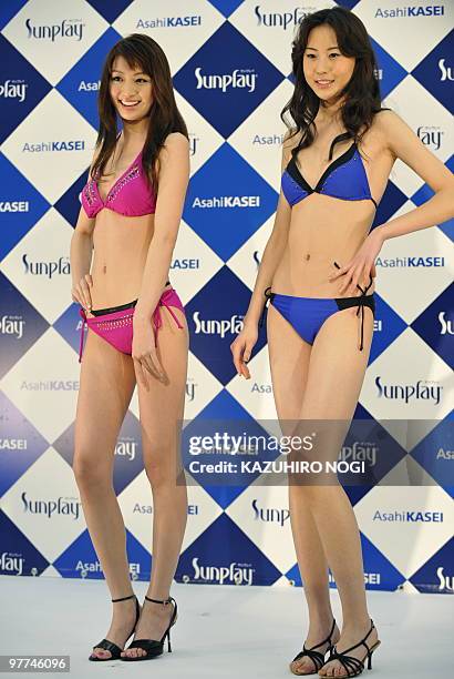 Campaign girls for Japanese swimwear maker Asahi Kasei, Yuki Shikanuma of Japan and Zhang Ziwei of China model the company's latest swimwear during a...